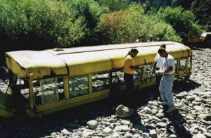 Hollywood stunt coordinators discuss the submerged bus near the North Fork of the American River.
