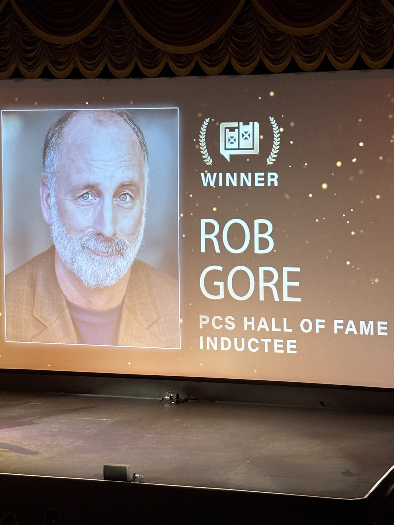 A theater screen with Rob Gore nominee showing.